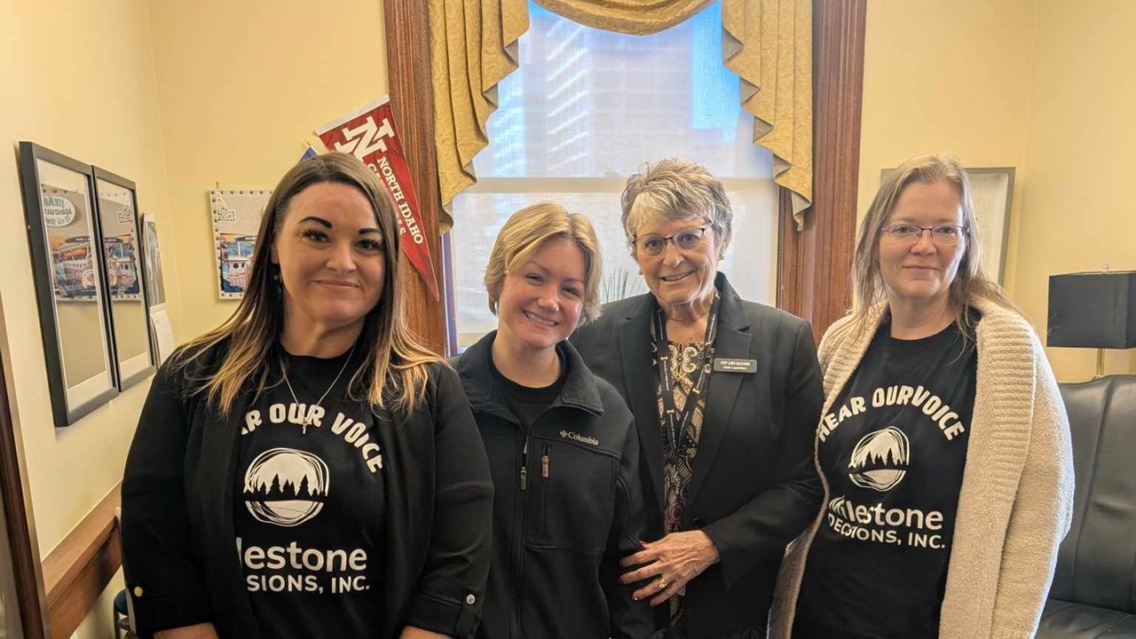 Thea Fuhs and two colleagues posing for a photo with Idaho State Representative Lori McCann