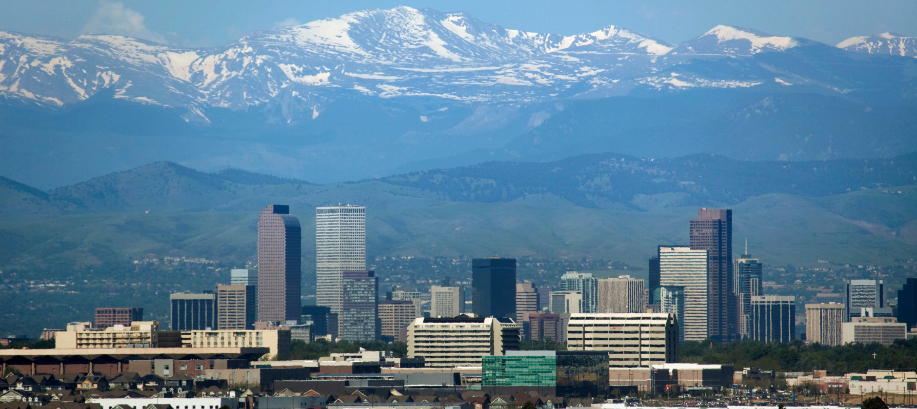 View of Denver skyline with Rocky Mountains in background